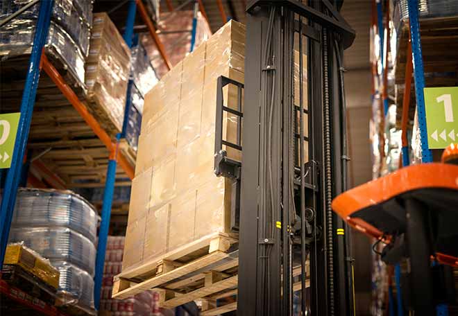 industrial-forklift-machine-lifting-palette-full-cardboard-boxes-placing-them-shelves-distribution-warehouse-facility.jpg